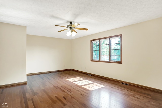8619 Wrangler Ct, Indianapolis, IN 46217 - empty room featuring hardwood / wood-style floors, a ceiling fan, baseboards, and a textured ceiling