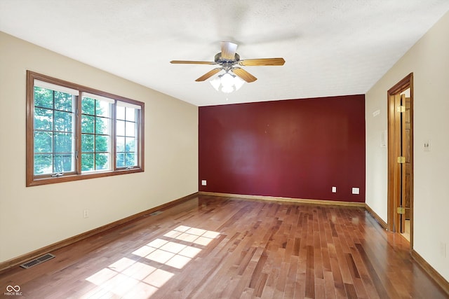 8619 Wrangler Ct, Indianapolis, IN 46217 - empty room featuring light wood-style floors, a ceiling fan, and baseboards