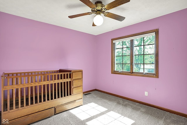 8619 Wrangler Ct, Indianapolis, IN 46217 - unfurnished bedroom featuring baseboards, carpet, and ceiling fan