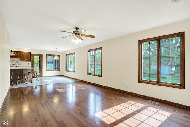 8619 Wrangler Ct, Indianapolis, IN 46217 - unfurnished living room with baseboards, a ceiling fan, and wood finished floors