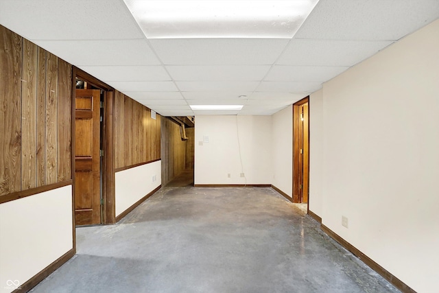 8619 Wrangler Ct, Indianapolis, IN 46217 - finished below grade area featuring wood walls, baseboards, and a paneled ceiling