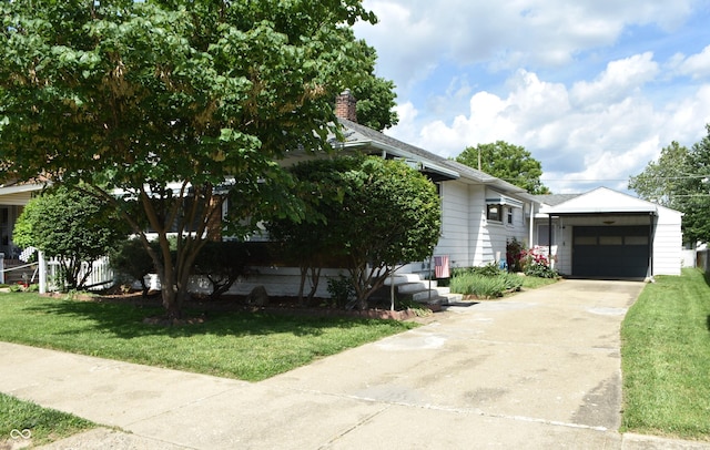 1641 Winton Ave, Speedway, IN 46224 - view of front of property featuring a front yard, driveway, a garage, and an outbuilding