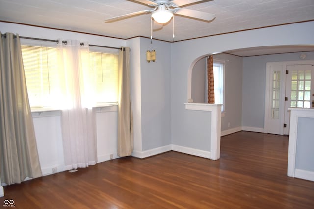 1641 Winton Ave, Speedway, IN 46224 - spare room featuring arched walkways, wood finished floors, ceiling fan, baseboards, and ornamental molding