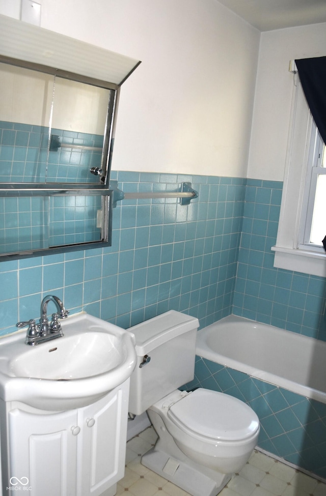 1641 Winton Ave, Speedway, IN 46224 - full bath with vanity, toilet, tiled bath, tile patterned floors, and tile walls