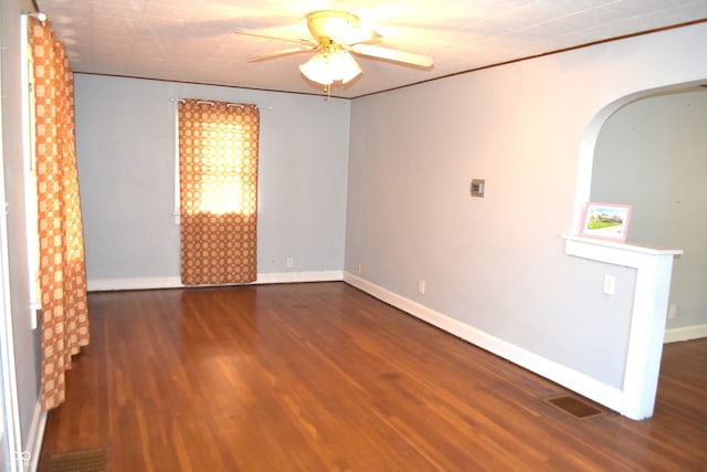 1641 Winton Ave, Speedway, IN 46224 - spare room featuring ceiling fan, wood finished floors, arched walkways, and baseboards