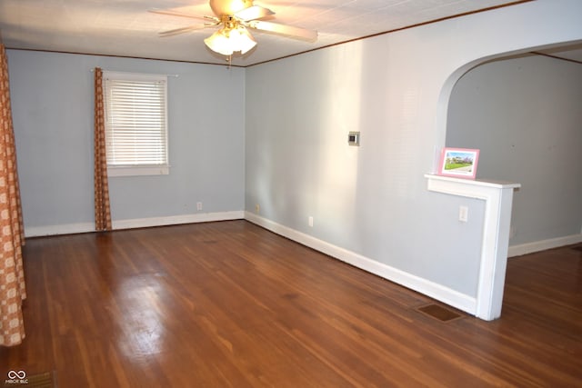 1641 Winton Ave, Speedway, IN 46224 - spare room with ceiling fan, wood finished floors, baseboards, arched walkways, and ornamental molding