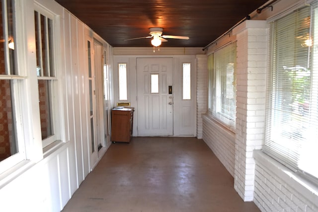 1641 Winton Ave, Speedway, IN 46224 - foyer featuring brick wall, ceiling fan, concrete floors, and wooden ceiling