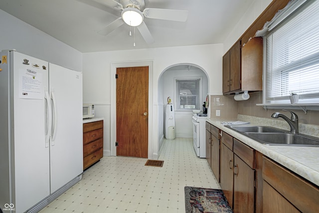 1641 Winton Ave, Speedway, IN 46224 - kitchen with white appliances, a sink, light floors, and light countertops
