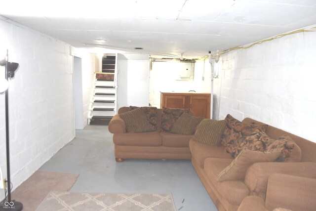 1641 Winton Ave, Speedway, IN 46224 - living area featuring concrete floors, stairs, and concrete block wall