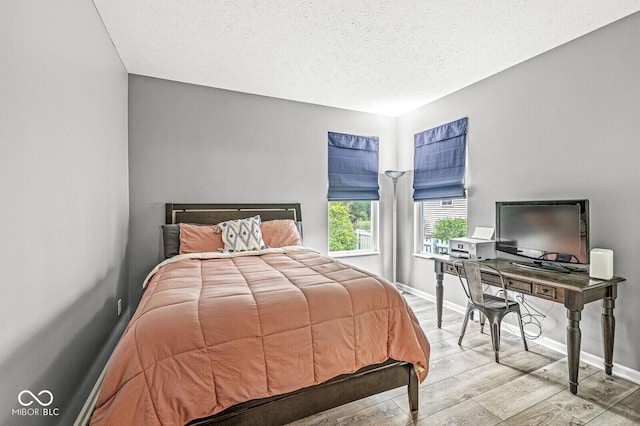 4642 Big Run Ct, Indianapolis, IN 46239 - bedroom with wood finished floors, a textured ceiling, and baseboards