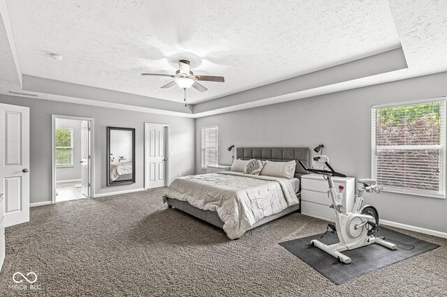 4642 Big Run Ct, Indianapolis, IN 46239 - carpeted bedroom featuring a textured ceiling, a tray ceiling, ceiling fan, and baseboards