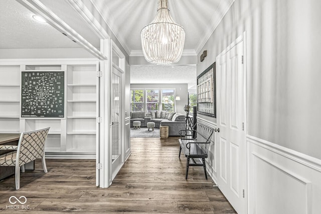 4642 Big Run Ct, Indianapolis, IN 46239 - hallway with crown molding, a chandelier, dark wood-type flooring, a wainscoted wall, and a decorative wall