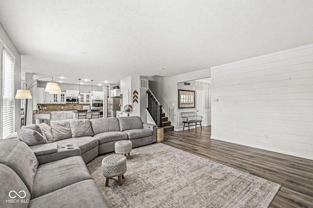 4642 Big Run Ct, Indianapolis, IN 46239 - living area featuring a textured ceiling, dark wood-type flooring, stairway, and baseboards