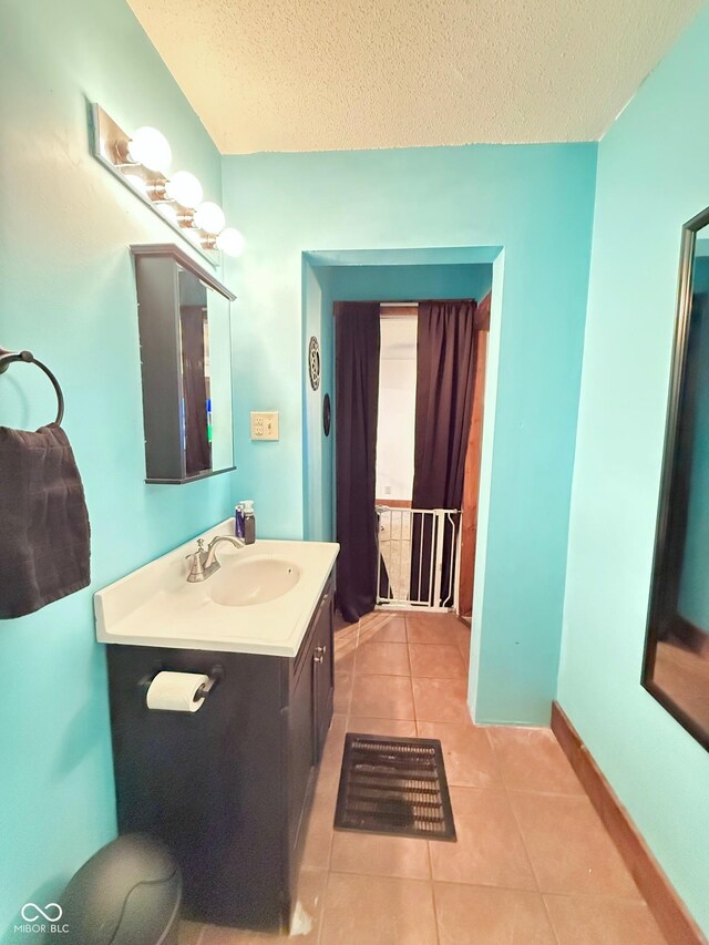 1126 S 20th St, New Castle, IN 47362 - bathroom with tile patterned flooring, vanity, a textured ceiling, and baseboards