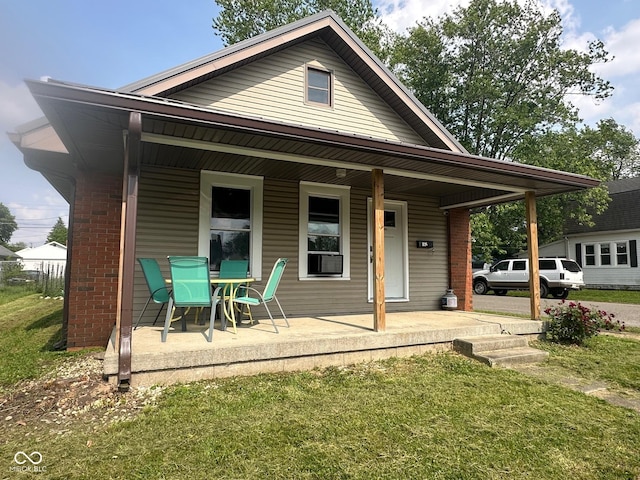 1126 S 20th St, New Castle, IN 47362 - back of property featuring covered porch, a lawn, and brick siding
