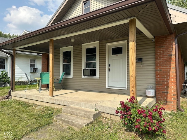 1126 S 20th St, New Castle, IN 47362 - entrance to property with covered porch, cooling unit, and brick siding