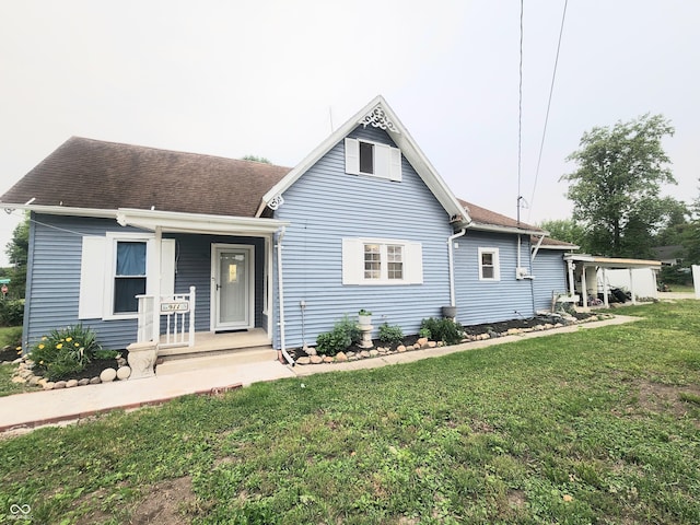 911 Samuel Milroy Rd, Delphi, IN 46923 - view of front of home featuring a front yard, covered porch, and roof with shingles