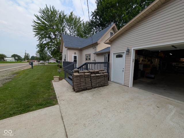 317 Washington St, Clay City, IN 47841 - view of home's exterior with a yard, a garage, concrete driveway, and a wooden deck