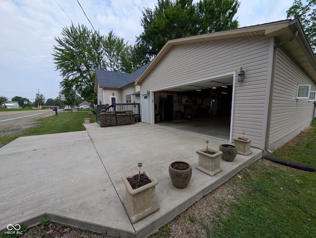 317 Washington St, Clay City, IN 47841 - view of side of home with an attached garage, concrete driveway, and a lawn