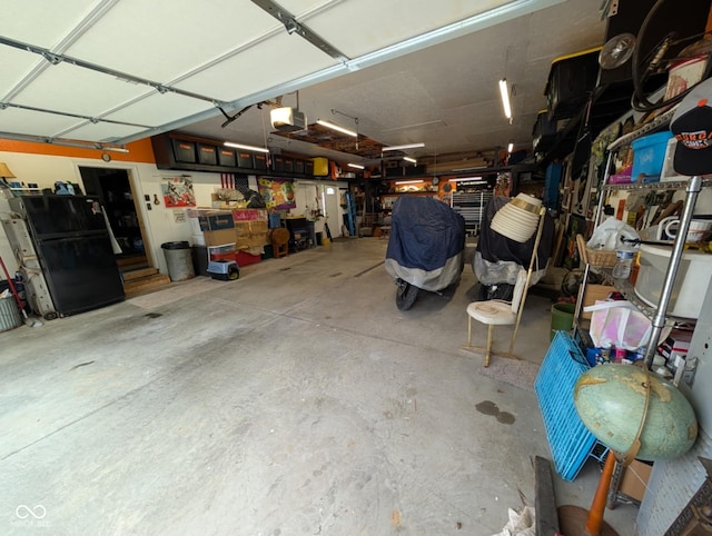 317 Washington St, Clay City, IN 47841 - garage with a garage door opener and freestanding refrigerator