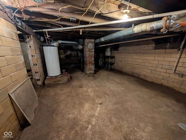 317 Washington St, Clay City, IN 47841 - unfinished below grade area featuring water heater and concrete block wall