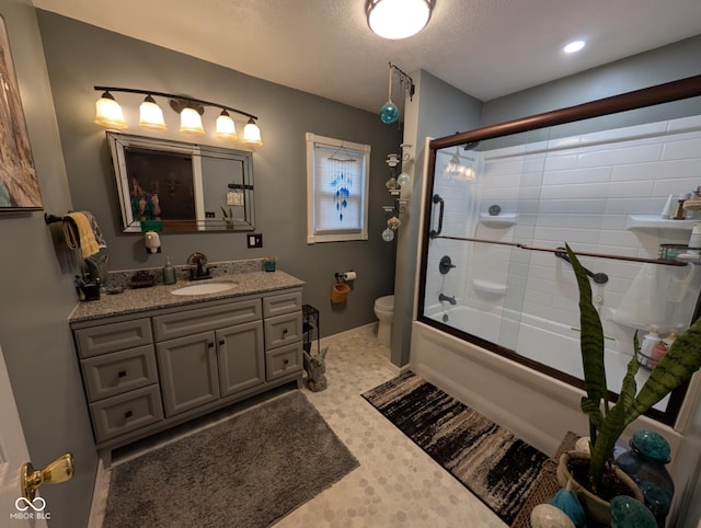 317 Washington St, Clay City, IN 47841 - bathroom with toilet, vanity, bath / shower combo with glass door, and a textured ceiling
