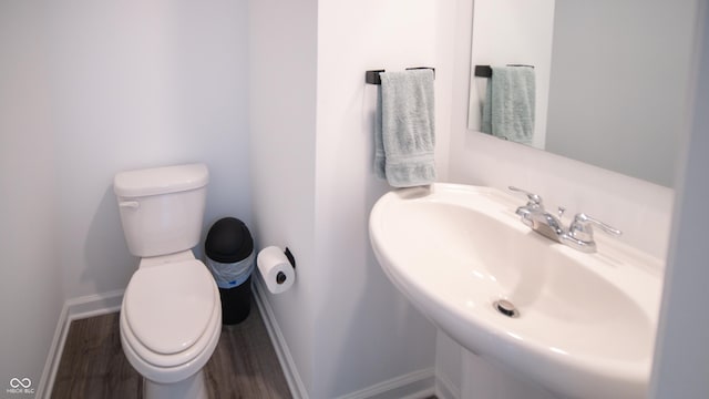 2916 W Bargello Ln, Monrovia, IN 46157 - bathroom featuring toilet, wood finished floors, a sink, and baseboards