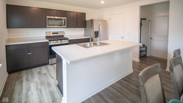 2916 W Bargello Ln, Monrovia, IN 46157 - kitchen with stainless steel appliances, a sink, light wood-type flooring, an island with sink, and light countertops