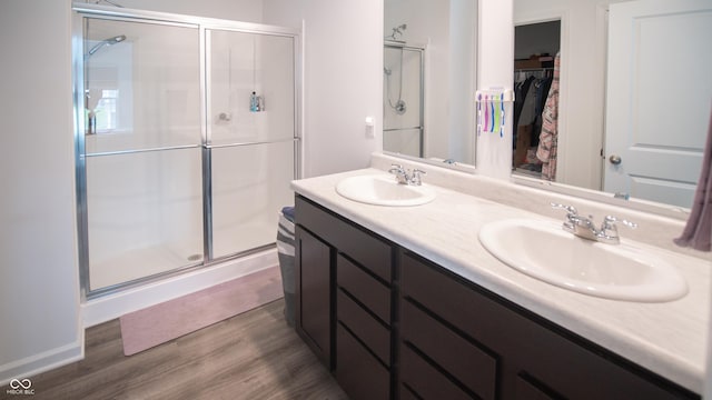 2916 W Bargello Ln, Monrovia, IN 46157 - bathroom with a shower stall, double vanity, wood finished floors, and a spacious closet