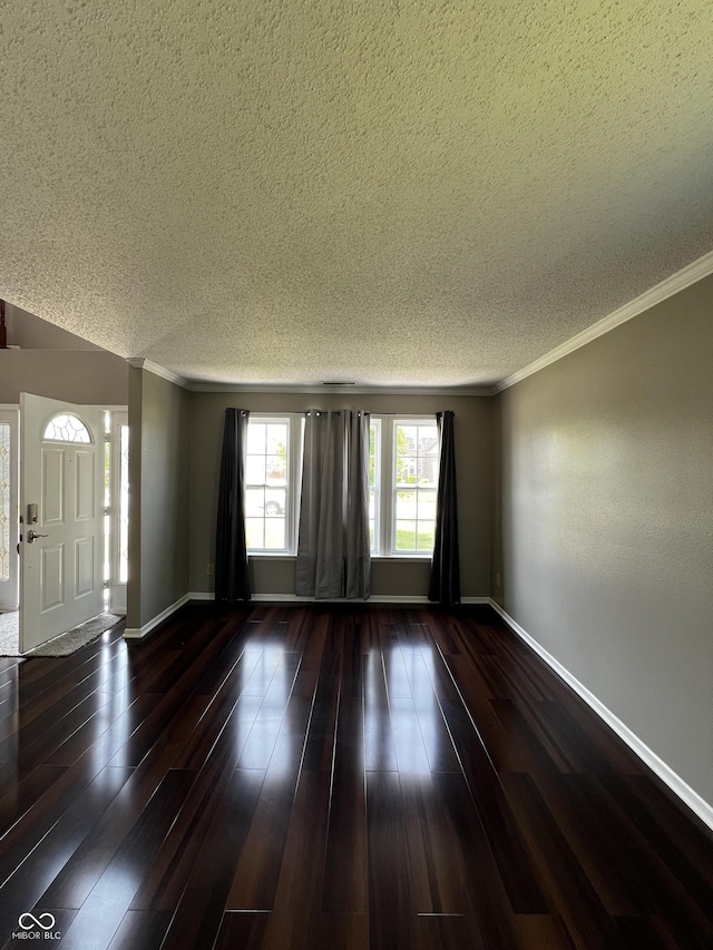 585 Fireside Dr, Greenwood, IN 46143 - unfurnished living room featuring a textured ceiling, ornamental molding, and hardwood / wood-style floors