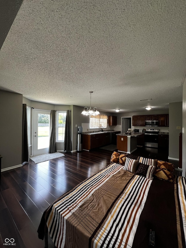 585 Fireside Dr, Greenwood, IN 46143 - dining space featuring a textured ceiling, a chandelier, and dark wood-style flooring