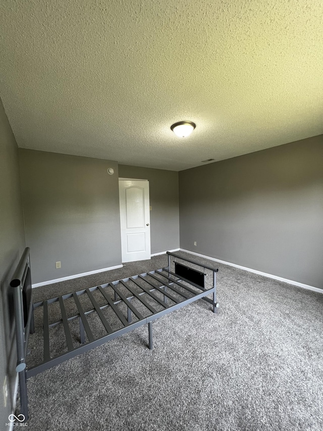 585 Fireside Dr, Greenwood, IN 46143 - carpeted empty room with a textured ceiling and baseboards
