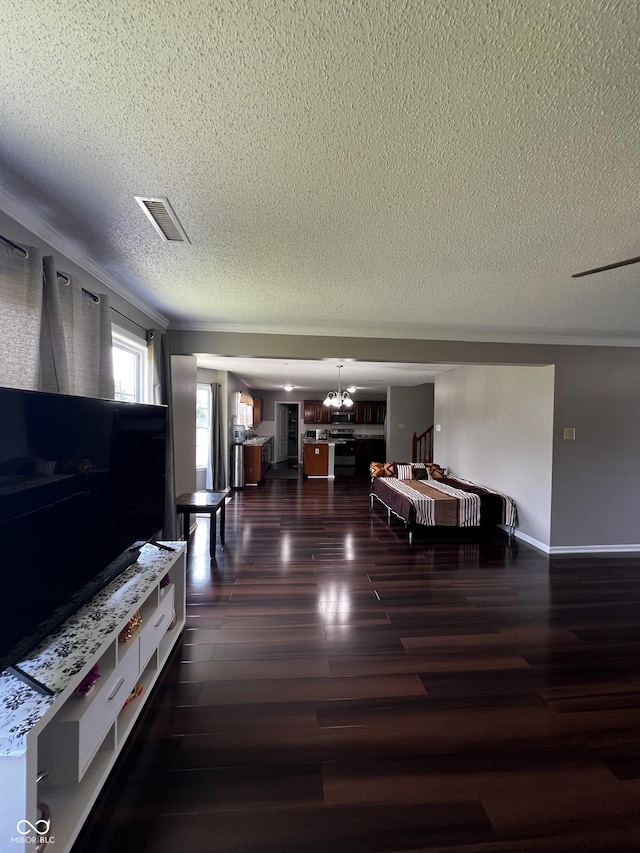 585 Fireside Dr, Greenwood, IN 46143 - living area featuring a textured ceiling, a chandelier, and wood finished floors