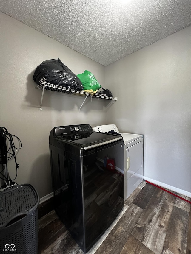 585 Fireside Dr, Greenwood, IN 46143 - laundry room with washing machine and dryer, dark wood finished floors, and a textured ceiling