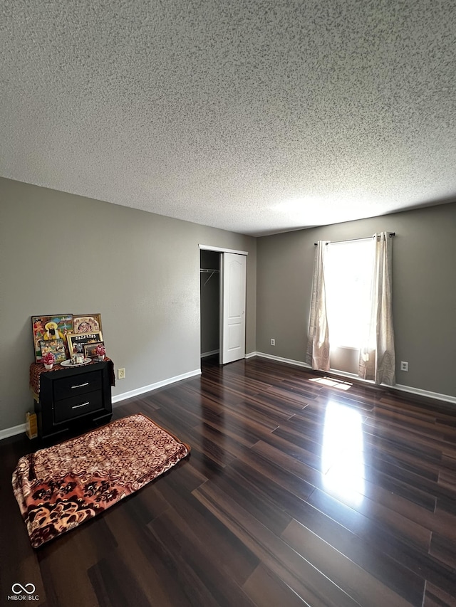 585 Fireside Dr, Greenwood, IN 46143 - bedroom featuring dark wood-style flooring, a textured ceiling, and a closet