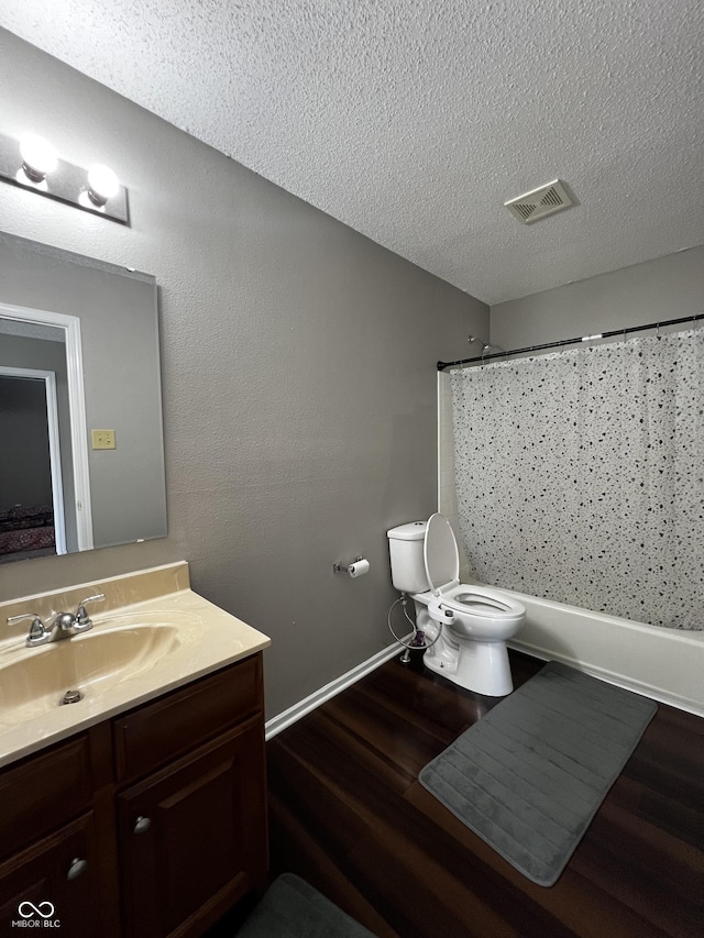 585 Fireside Dr, Greenwood, IN 46143 - bathroom featuring vanity, wood finished floors, a textured ceiling, and shower / bathtub combination with curtain