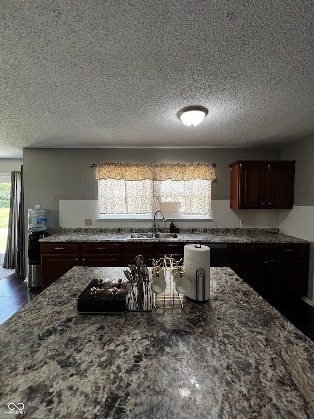 585 Fireside Dr, Greenwood, IN 46143 - kitchen with a textured ceiling, dark stone countertops, and dark brown cabinets