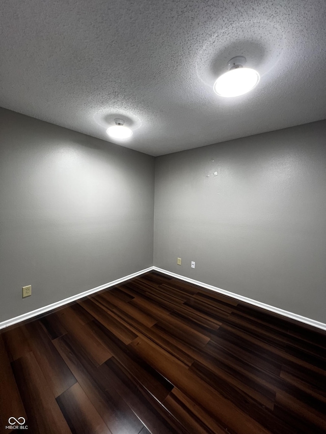 585 Fireside Dr, Greenwood, IN 46143 - spare room with dark wood-type flooring and a textured ceiling