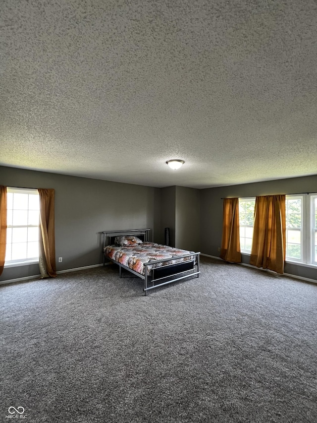 585 Fireside Dr, Greenwood, IN 46143 - carpeted bedroom featuring a textured ceiling and baseboards