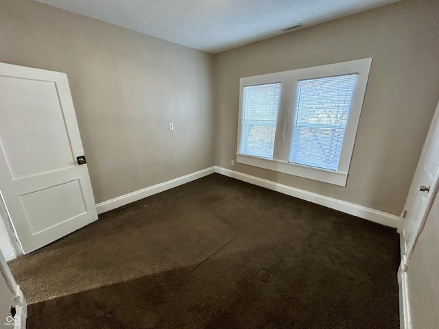307 N Arlington Ave, Indianapolis, IN 46219 - spare room featuring dark colored carpet and baseboards