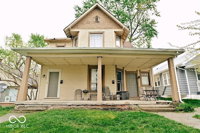 307 N Arlington Ave, Indianapolis, IN 46219 - victorian-style house featuring a porch and a front lawn