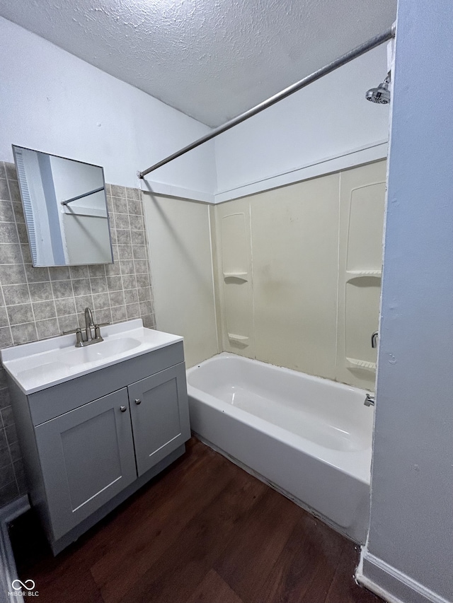 307 N Arlington Ave, Indianapolis, IN 46219 - full bathroom featuring wood finished floors, vanity, shower / washtub combination, and a textured ceiling