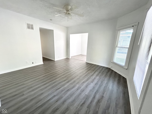 307 N Arlington Ave, Indianapolis, IN 46219 - spare room with dark wood-style floors, ceiling fan, baseboards, and a textured ceiling