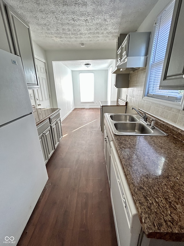307 N Arlington Ave, Indianapolis, IN 46219 - kitchen featuring white appliances, a sink, dark wood finished floors, plenty of natural light, and a textured ceiling