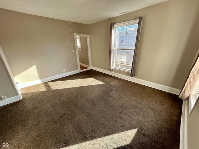 307 N Arlington Ave, Indianapolis, IN 46219 - empty room featuring dark carpet and baseboards