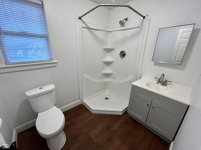 307 N Arlington Ave, Indianapolis, IN 46219 - bathroom featuring wood finished floors, a shower, vanity, toilet, and baseboards