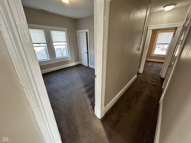 307 N Arlington Ave, Indianapolis, IN 46219 - hall with dark colored carpet, baseboards, and healthy amount of natural light