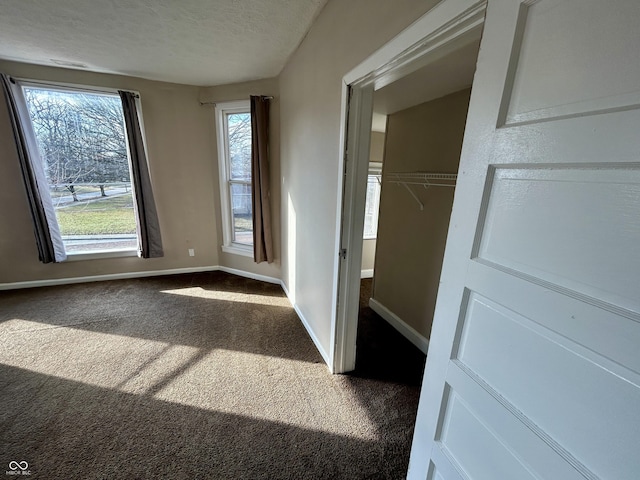 307 N Arlington Ave, Indianapolis, IN 46219 - unfurnished bedroom with carpet flooring, baseboards, a textured ceiling, and a closet