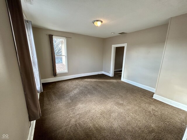 307 N Arlington Ave, Indianapolis, IN 46219 - empty room with dark carpet and baseboards
