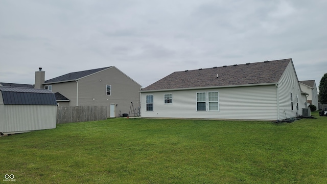 713 Driftwood Cir, Danville, IN 46122 - rear view of house featuring cooling unit and roof with shingles